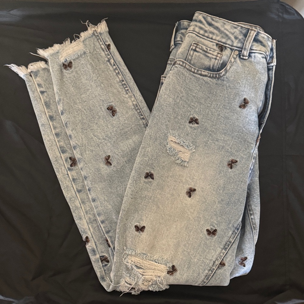 Distressed Light Blue Jeans with Embroidered Butterfly Details